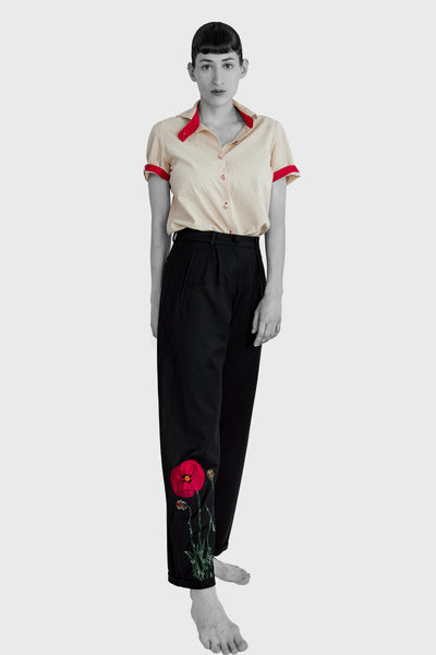 a handmade Wild poppy flower embroidered on tailored trousers, made in Italian soft wool, black color with red and green poppy flower embroidery, elegant chic style, style trousers with a shirt tucked in your trousers, silk shirt or office wear. designed by Ruxandra