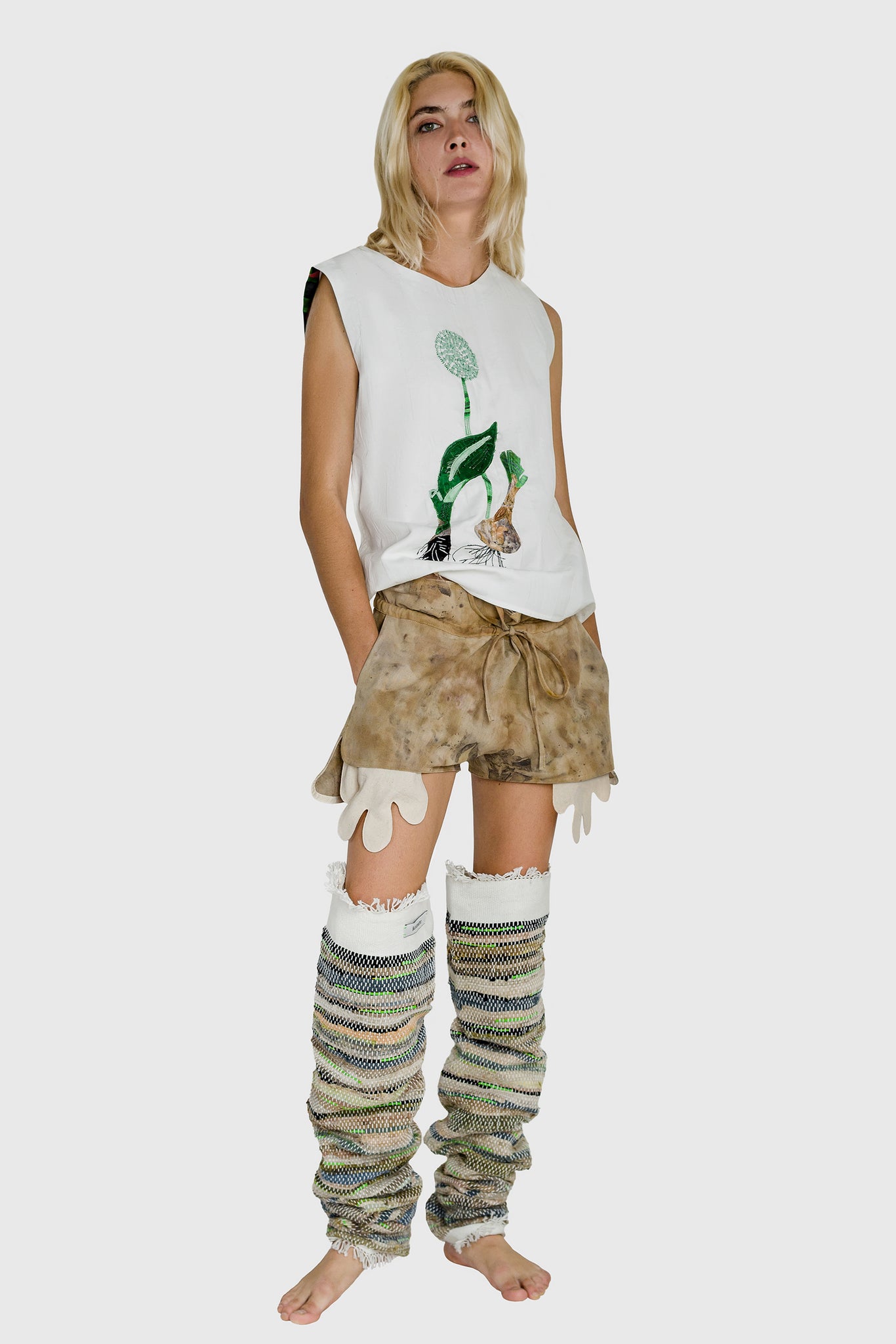 women's embroidered t-shirt, mini shorts and leg warmers, all cool and baggy streetwear, hands showing in shorts
