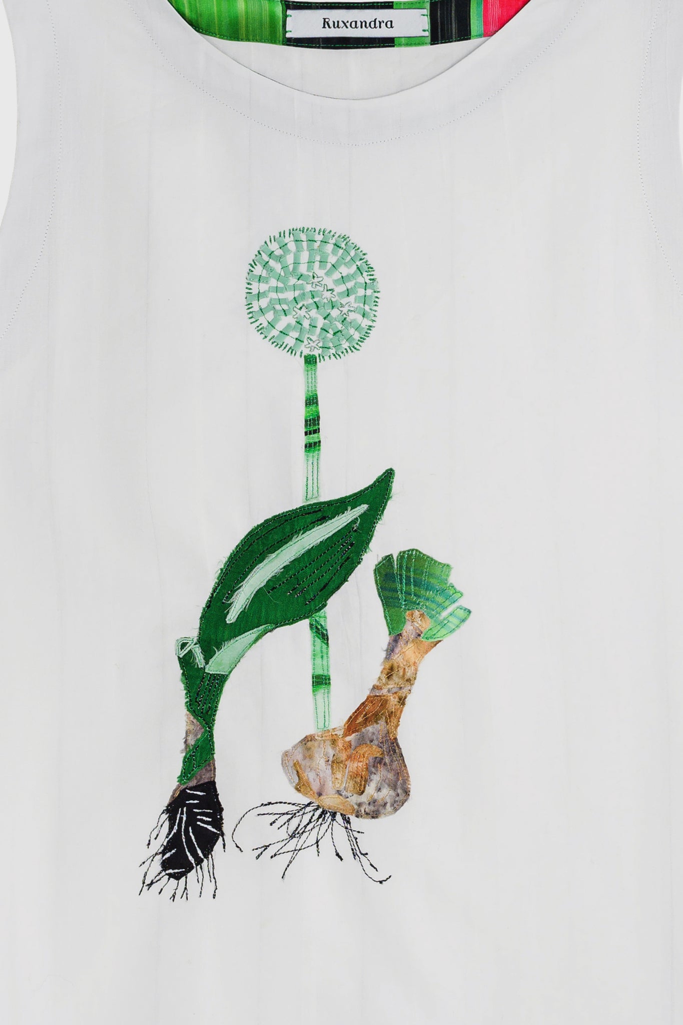 T-shirt with detailed embroidery, of a onion and onion flower, beautiful and exquisite graphic, seen from afar, interesting to style with business outfits or casual wear, 