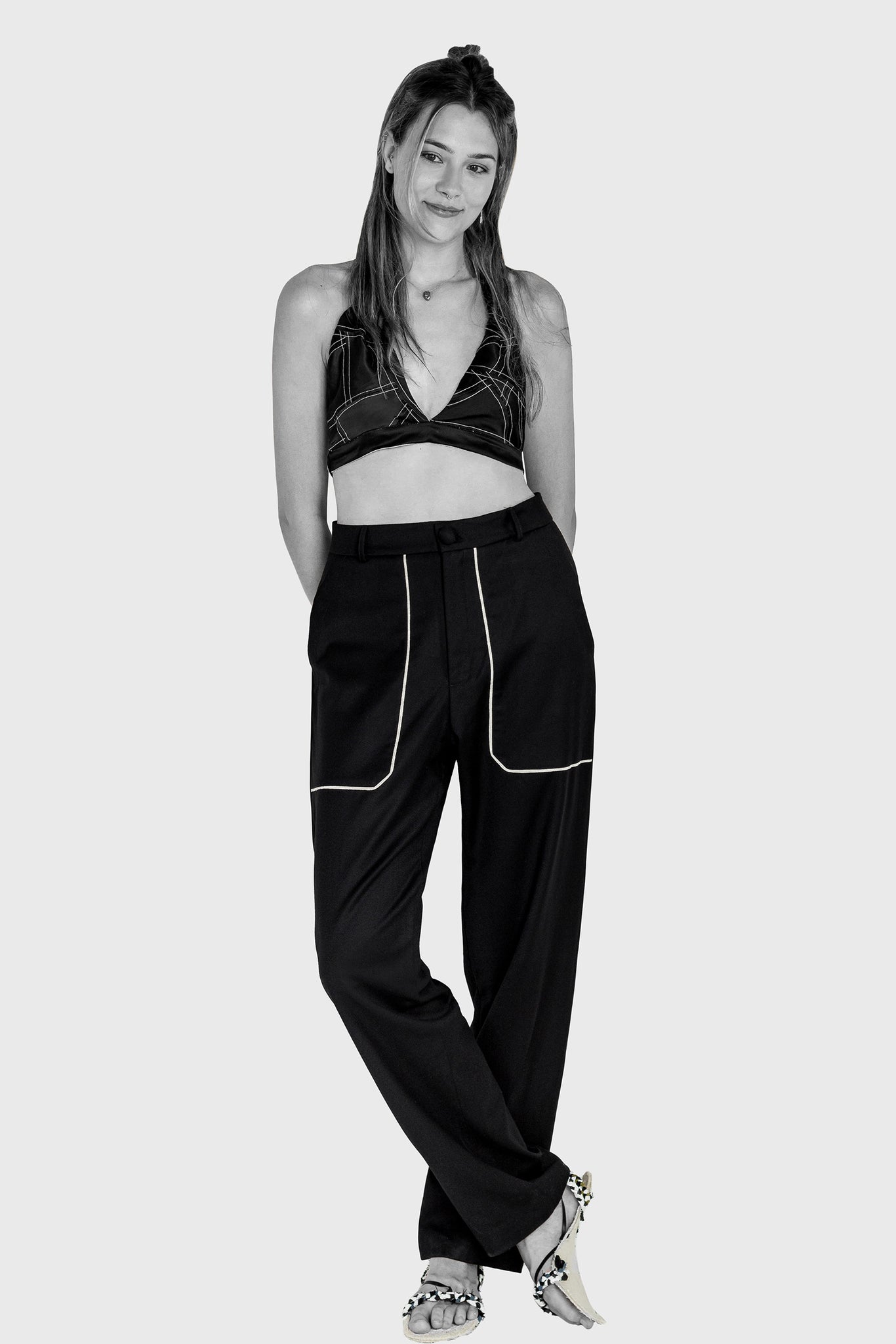 Ruxandra fashion, all black look, spring summer, upcycled silk bra with white thread over, black wool long trousers, super casual fun look.
