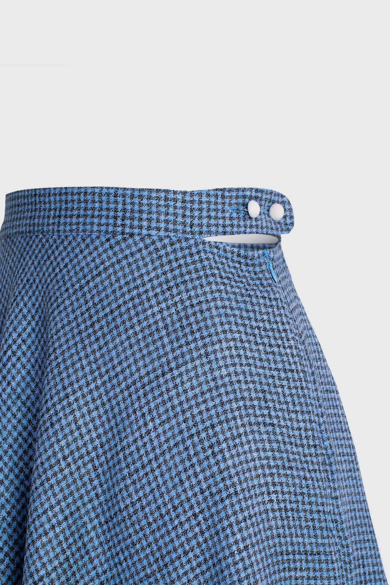 skirt detail, waistband for a better fit, cutout on the side revealing the waist, button up and zipper side closure, two covered buttons, highly bespoke houndstooth Italian textile, luxury super merinos silk and linen