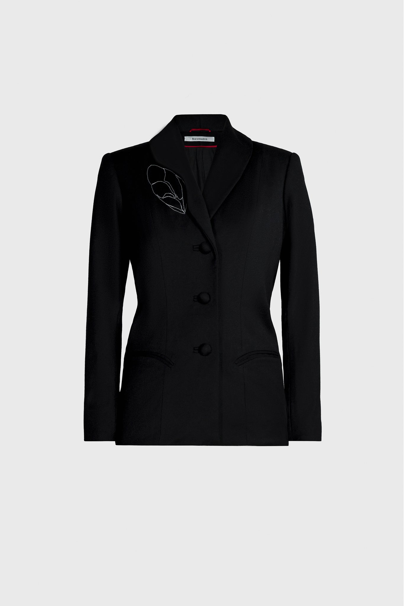 Ruxandra, long tailored jacket, cut out lapel around a manual thread embroidery, cocoon shell, white thread contrasting the jet black, curved sleeves, medieval cut, armor like silhouette, elegant edgy style 