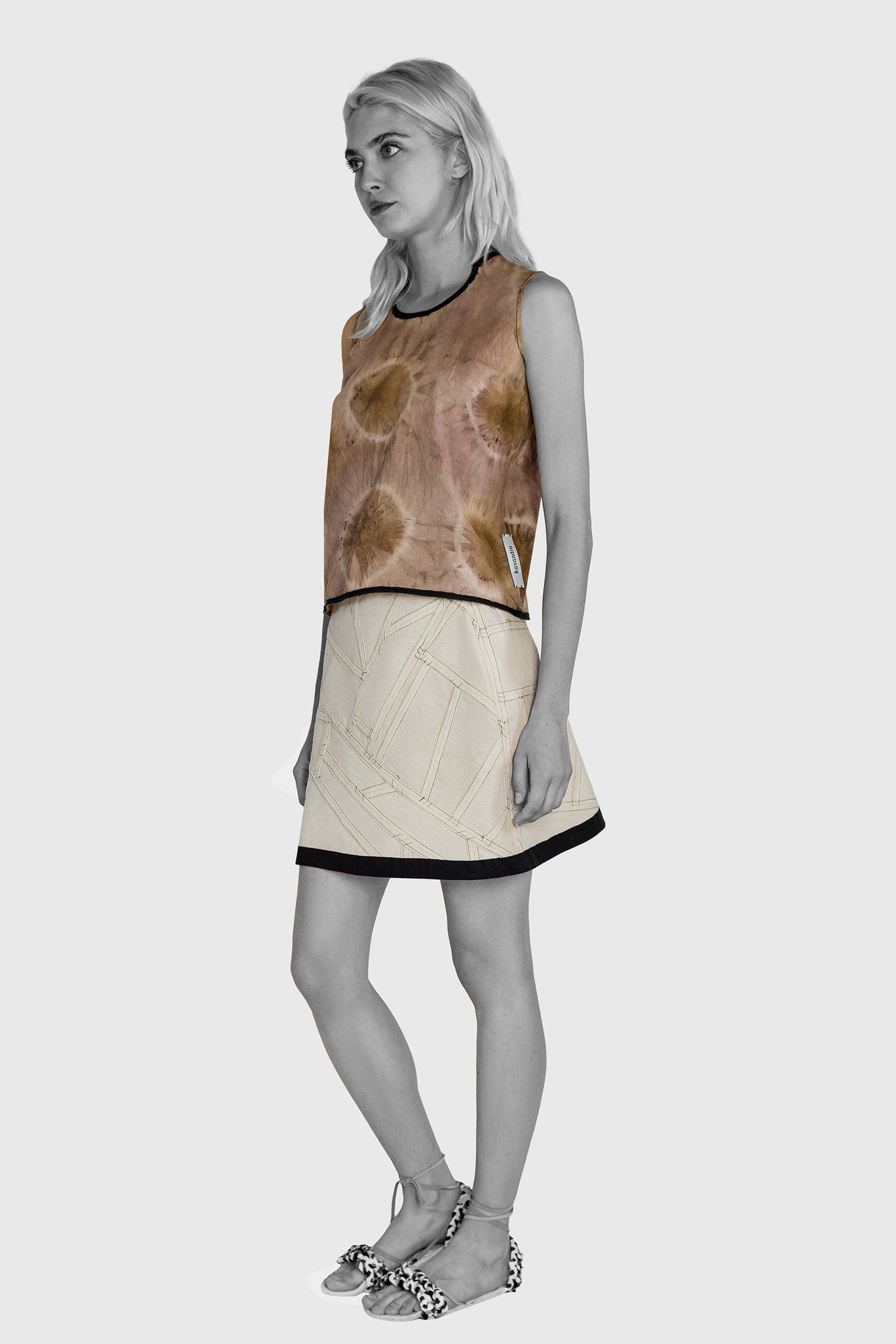 Ruxandra designed short skirt, patchwork design, different direction of cotton patches, outlined by black wool, black and white avantgarde style, futuristic technical textile, paired with natural dyed Shibori sleeveless T-shirt